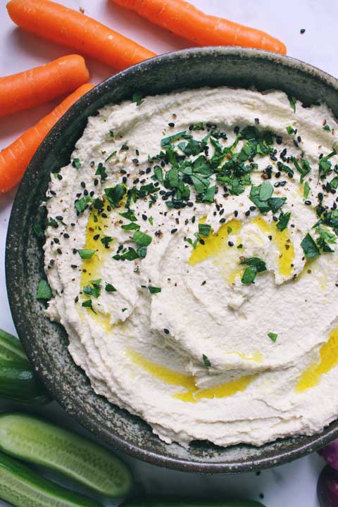 Closeup shot of handmade bowl filled with paleo gut friendly bean free hummus