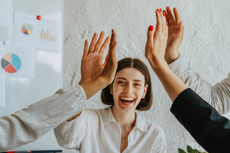 Woman smiling and high-fiving